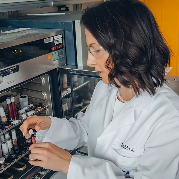 Cosmetic chemist examining formulation
