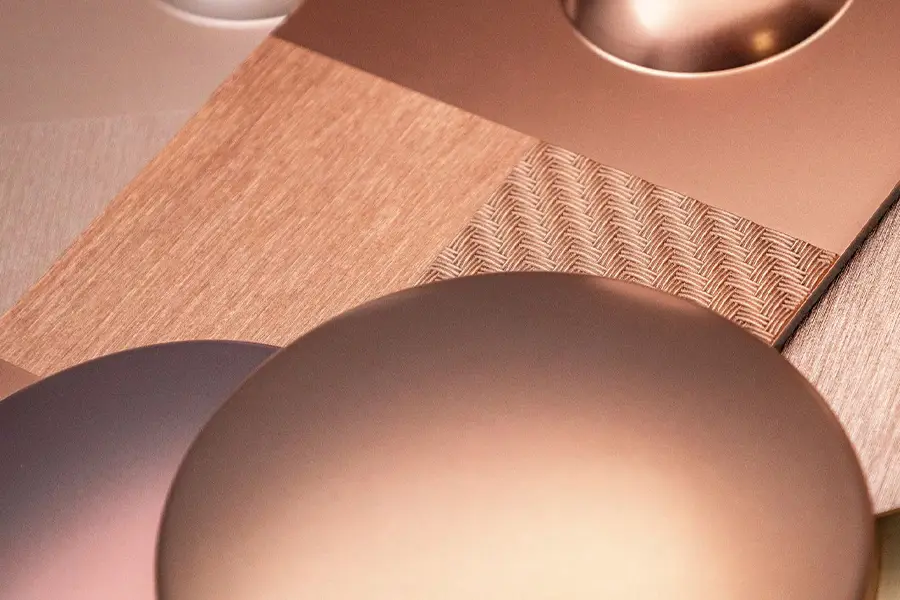 Close up of textured shapes coated with a peach colored pigment combination